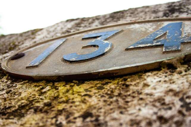 a house address on a stone wall