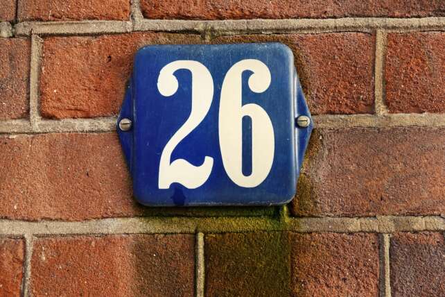 a civic number on a brick wall