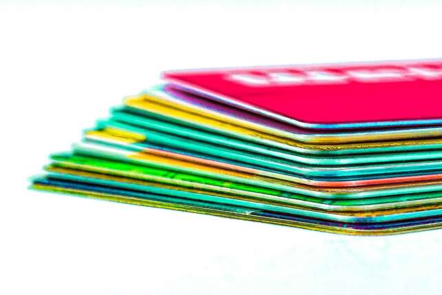 a stack of credit cards in multiple colors