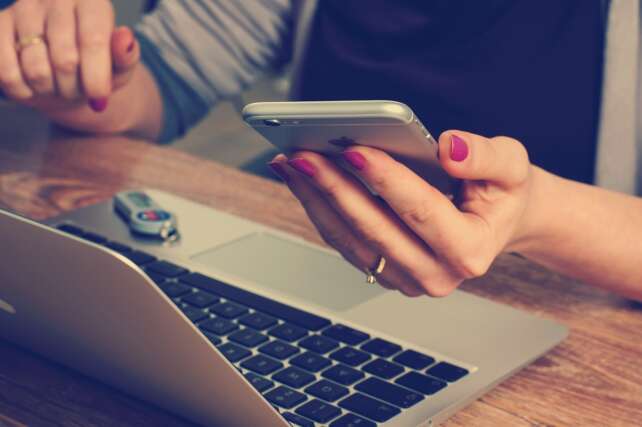 lady with her cellphone and a laptop