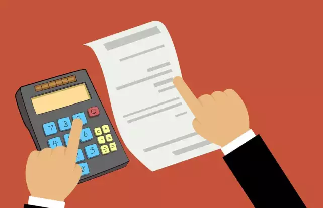 person inputing numbers on a calculator for their taxes